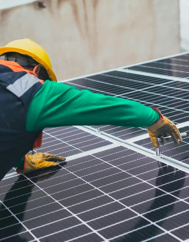 A engineer installing a solar panel on a roof