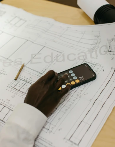 A calculator on top of detailed solar design plans